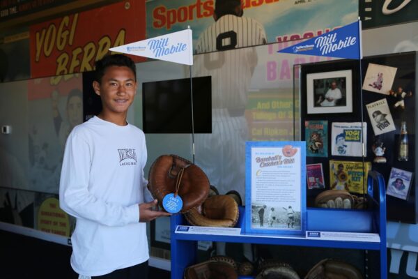 Boy holding a catcher's mitt from the Mitt Mobile