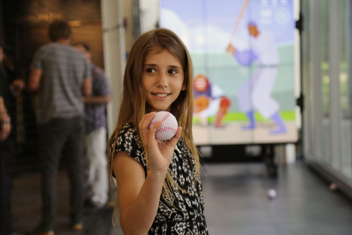 Girl with a baseball at the Pitch! exhibition