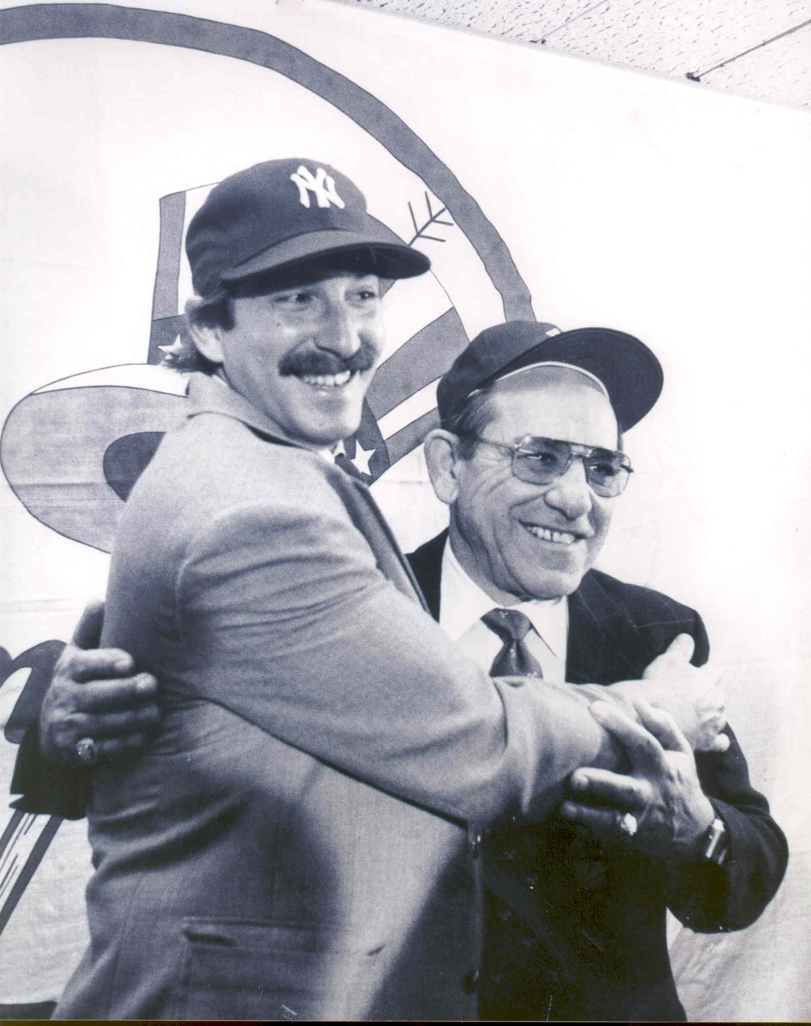 Yogi and Dale Berra hugging and posing for pictures