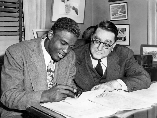 Jackie Robinson signs a contract with Branch Rickey in 1946