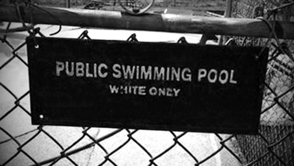 Sign posted saying "Public Swimming Pool White Only".