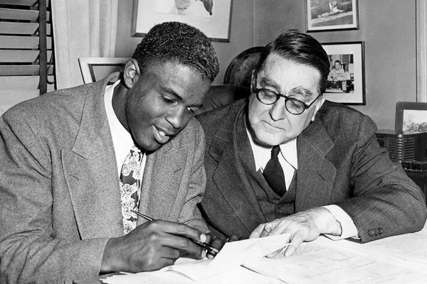 Black baseball player being signed.