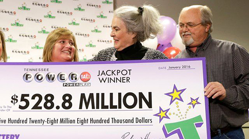 Photo of a lottery winner holding a $528.8 Million powerball poster