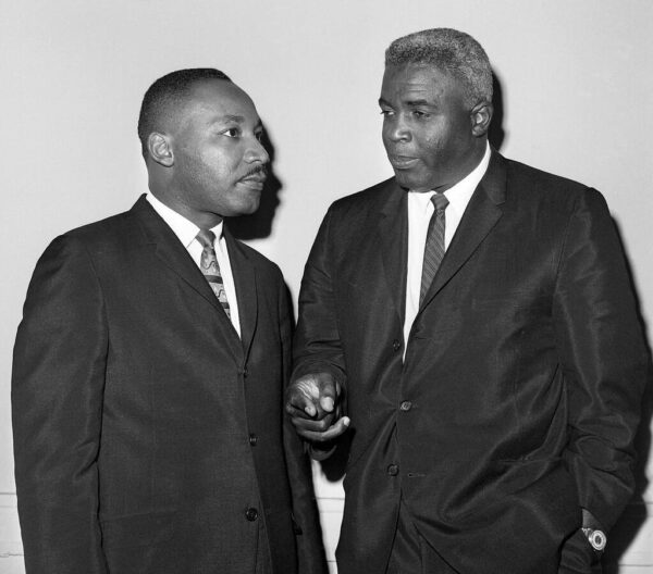 Photo of Jackie Robinson standing beside Martin Luther King, Jr.