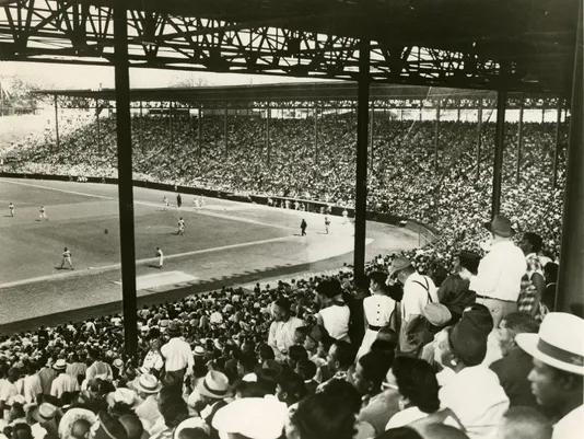 Baseball stadium packed with spectators. 