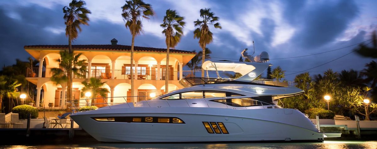Yacht in front of mansion villa