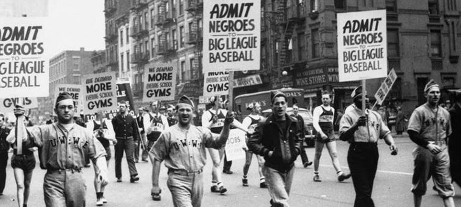 People marching holding signs for African American rights.
