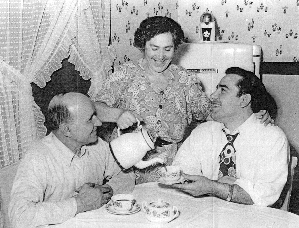 Yogi Berra and his parents at the dinner table drinking tea