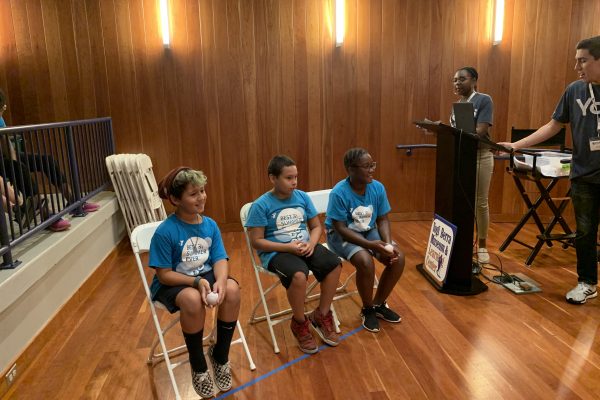 Three students in the auditorium at the Museum