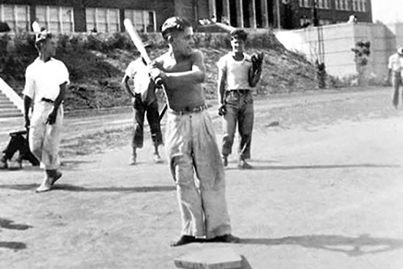 Yogi Berra extends a congratulatory hand as Joe DiMaggio comes