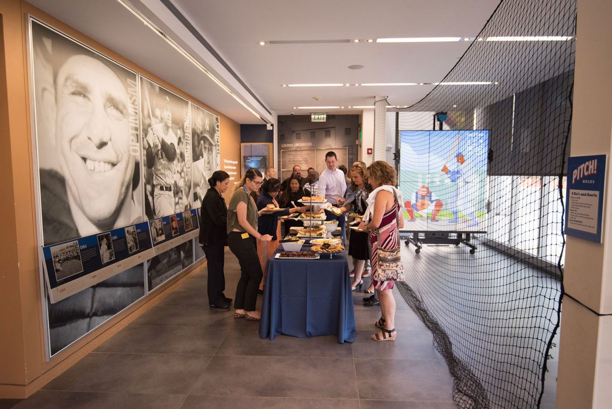 Event guests at a food table in the Museum