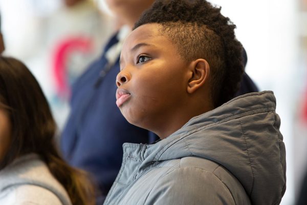 Young students looking inquisitively during an event at the Museum