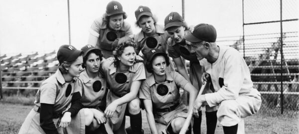 Members of the all-female baseball team the Rockford Peaches gathered on the field