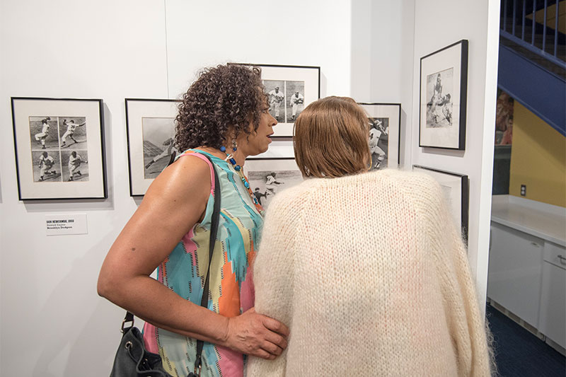 Two visitors look at one of the exhibit photos.