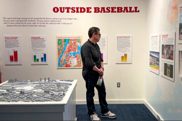 Man reviewing Handling the Curve Exhibit on opening night